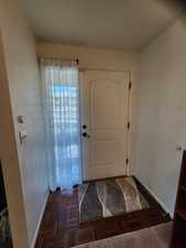 Doorway to outside with baseboards