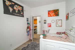 Bedroom with light wood-type flooring and baseboards