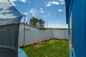 View of yard featuring a fenced backyard and a gate