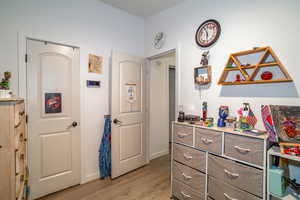 Bedroom featuring baseboards and light wood-style flooring