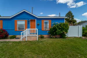 Bungalow-style home featuring fence and a front yard