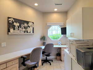Home office featuring built in desk, recessed lighting, visible vents, and light tile patterned floors