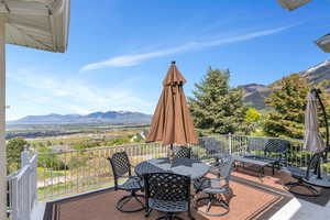Deck with a mountain view and outdoor dining area