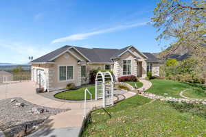 Single story home featuring stucco siding, concrete driveway, and a front yard