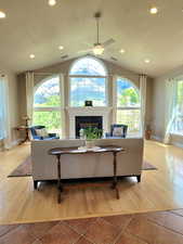 Living room featuring baseboards, lofted ceiling, and hardwood / wood-style floors