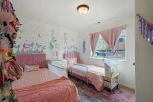 Bedroom with baseboards, visible vents, and carpet