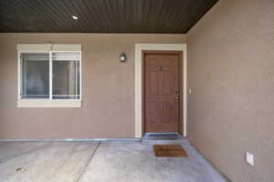 View of exterior entry featuring stucco siding