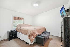 Bedroom with light colored carpet