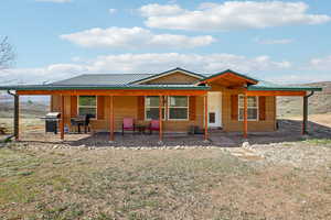Back of house featuring metal roof