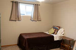 Carpeted bedroom featuring baseboards