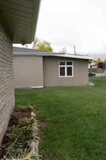 View of side of property with a yard