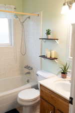 Full bathroom with vanity, shower / bathtub combination, and toilet