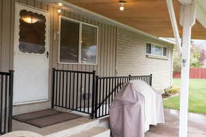 View of exterior entry featuring brick siding