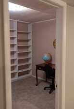 Carpeted office featuring baseboards and ornamental molding