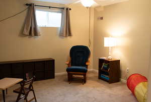 Living area featuring light colored carpet, baseboards, and visible vents
