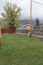 View of yard featuring a fenced backyard and a mountain view