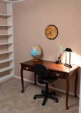 Office space featuring baseboards and carpet