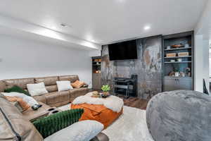 Living room featuring recessed lighting,  built in features, and wood finished floors