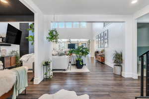 Living room with baseboards, recessed lighting, and wood finished floors