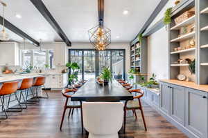 Dining space featuring recessed lighting, a notable chandelier, dark wood-style floors, and beam ceiling