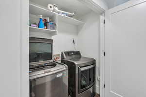 Clothes washing area featuring laundry area and washing machine and clothes dryer