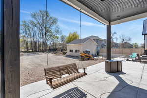 View of patio with fence, an outdoor living space,