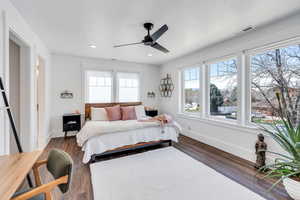 Bedroom featuring ceiling fan, dark wood-style flooring,
