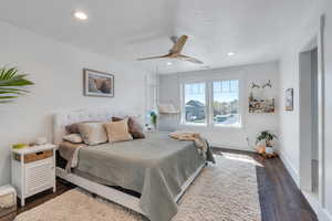 Bedroom featuring dark wood-style flooring, ceiling fan,