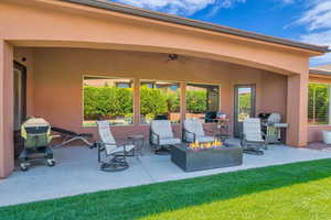 View of patio / terrace featuring grilling area, ceiling fan, and an outdoor fire pit