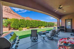 View of patio / terrace featuring ceiling fan, a grill, and a fire pit