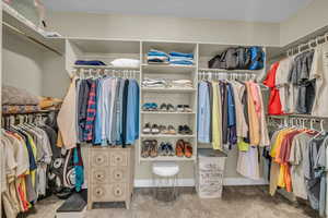 Spacious closet with carpet flooring