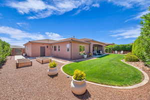 Back of house with a lawn, fence, a patio, and stucco siding