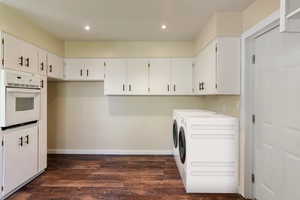 Laundry area with laundry area, dark wood finished floors, baseboards, separate washer and dryer, and recessed lighting