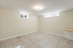 Bedroom featuring baseboards and light tile patterned floors