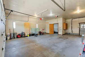 Garage with a garage door opener and storage room