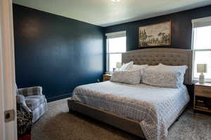 Bedroom with multiple windows and carpet flooring