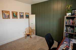 Home office with carpet floors and baseboards