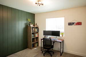 Carpeted office space featuring baseboards