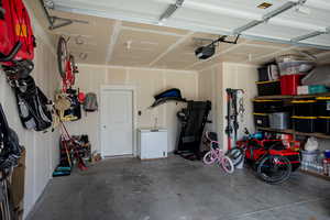 Garage with a garage door opener and fridge