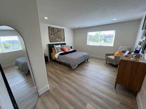 Bedroom with recessed lighting, baseboards, and light wood-type flooring