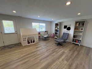 Sitting room with recessed lighting, baseboards, visible vents, and light wood-style floors