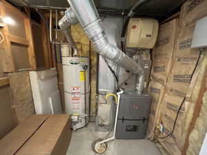 Utility room featuring gas water heater