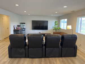 Living room featuring recessed lighting, baseboards, visible vents, and light wood-type flooring