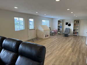 Playroom with a healthy amount of sunlight, recessed lighting, and wood finished floors