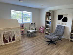 Game room with recessed lighting, visible vents, and light wood finished floors