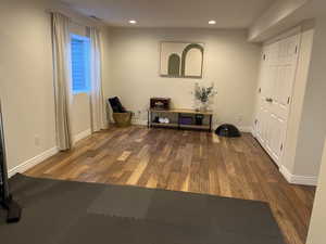 Interior space featuring baseboards, recessed lighting, and wood finished floors