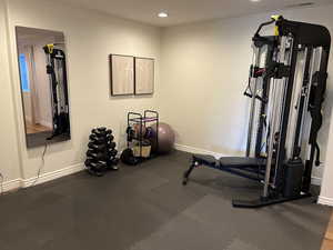 Exercise area with baseboards and recessed lighting