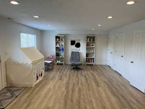 Interior space with recessed lighting, wood finished floors, and visible vents