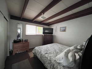 Bedroom featuring beam ceiling