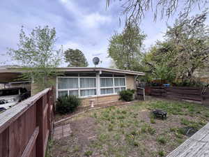 Exterior space with brick siding, fence, and a fire pit